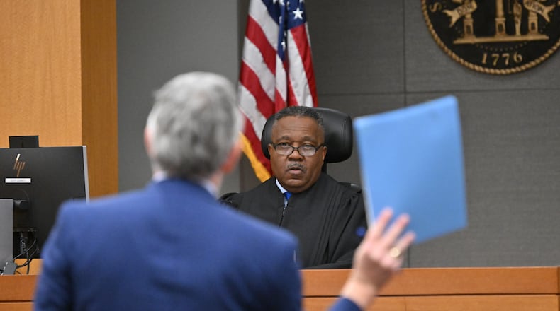 Attorney Chris Anulewicz (foreground) representing Republican plaintiffs speaks in front of Fulton County Superior Court Judge Thomas Cox (background) in a case against State Election Board rules in Fulton County Superior Court, Wednesday, October 16, 2024, in Atlanta. (Hyosub Shin / AJC)