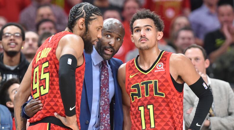 Atlanta Hawks head coach Lloyd Pierce instruct Atlanta Hawks forward DeAndre' Bembry (95) and Atlanta Hawks guard Trae Young (11) during the second half of the home opener in an NBA basketball game at State Farm Arena on Wednesday, October 24, 2018. HYOSUB SHIN / HSHIN@AJC.COM