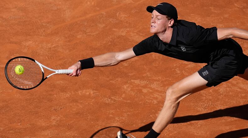 Italy's Jannik Sinner stretches to return the ball to Australia's Alexei Popyrin, during their match at the Italian Open tennis tournament in Rome, Monday, May 11, 2026. (AP Photo/Alessandra Tarantino)