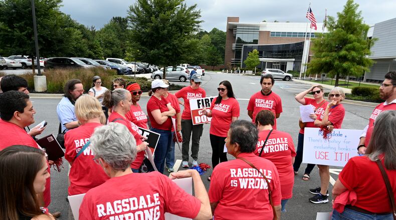 Jennifer Susko (center) leads Cobb County community members as they rally to demand the removal of Superintendent Chris Ragsdale outside the district offices on Thursday, Sept. 14, 2023, in Marietta.  (Hyosub Shin / Hyosub.Shin@ajc.com)