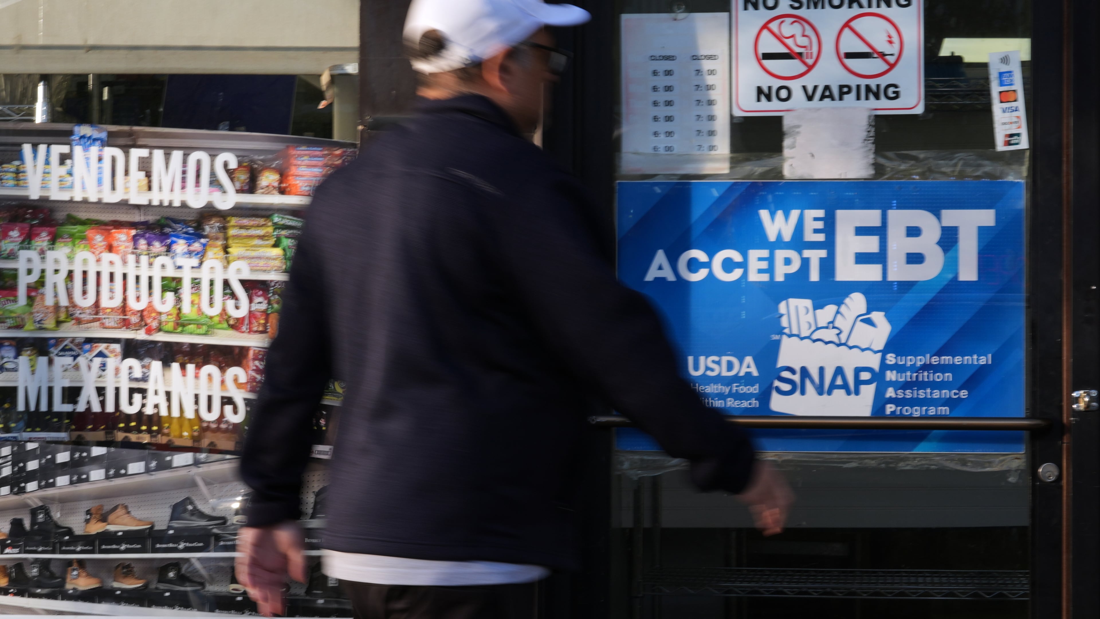 A customer walks into a bakery as a SNAP EBT information sign is displayed at the front door in Chicago, Sunday, Nov. 2, 2025. (AP Photo/Nam Y. Huh)