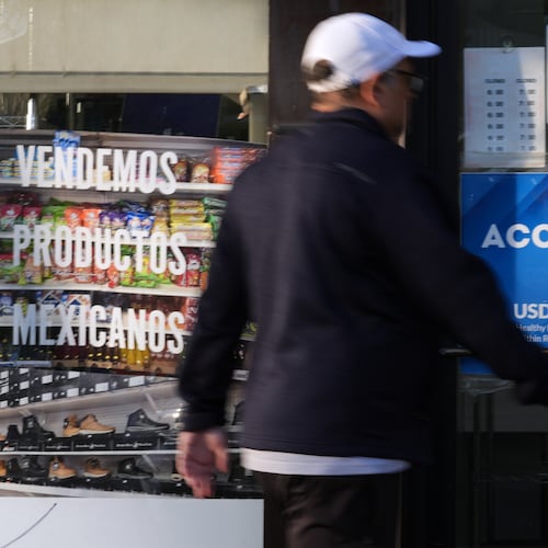 A customer walks into a bakery as a SNAP EBT information sign is displayed at the front door in Chicago, Sunday, Nov. 2, 2025. (AP Photo/Nam Y. Huh)