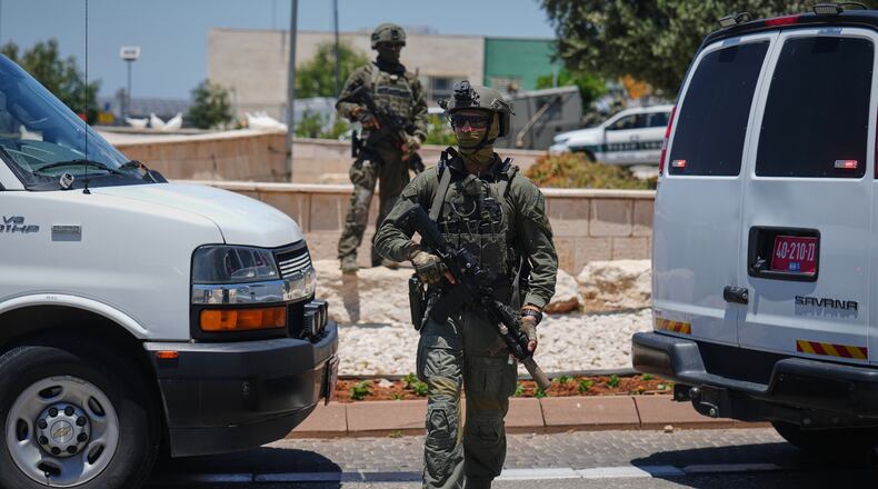 Israeli security forces are deployed at the scene of a shooting attack carried out by a Palestinian citizen of Israel near Tzur Yitzhak in central Israel, Sunday, June 7, 2026. (AP Photo/Ariel Schalit)