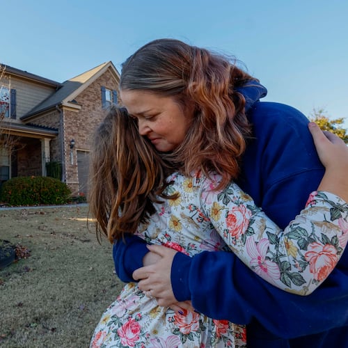 Angela Cassandra hugs her daughter, Avery, upon her return from school on Wednesday, Nov. 12, 2025. Angela, 41, had undergone a transplant 11 years earlier, which enabled her to continue living, marry her boyfriend, Daniel, and later have Avery. After having a second transplant earlier this year, she and her family feel profoundly grateful, especially as Thanksgiving approaches. (Miguel Martinez/AJC)