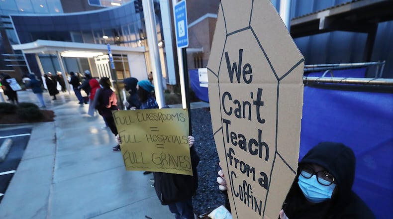 012121 Marietta: High school teacher Elizabeth Alentyeu is among hundreds of Cobb County teachers and staff hold a protest in the parking lot during the school board meeting at the Cobb County School District's Offices on Thursday, Jan. 21, 2021, in Marietta. Cobb teachers are pressing the district for improved COVID-19 response.  Curtis Compton / Curtis.Compton@ajc.com”