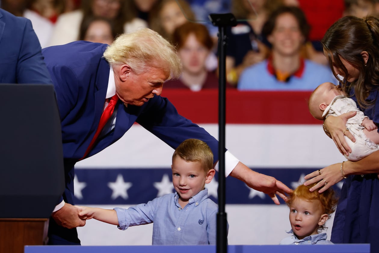 President Donald Trump greets members of the Loden family, who signed up for Trump Accounts, during his rally at Wheeler High School on Wednesday, July 22, 2026, in Marietta. (Arvin Temkar/AJC)
