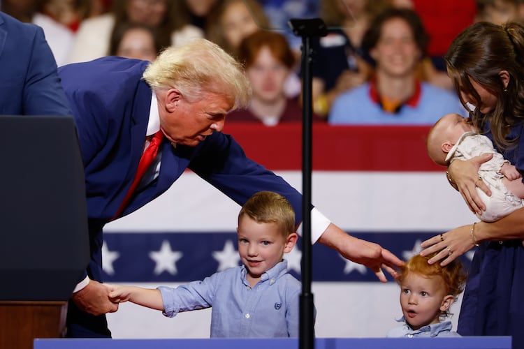 President Donald Trump greets members of the Loden family, who signed up for Trump Accounts, during his rally at Wheeler High School on Wednesday, July 22, 2026, in Marietta. (Arvin Temkar/AJC)