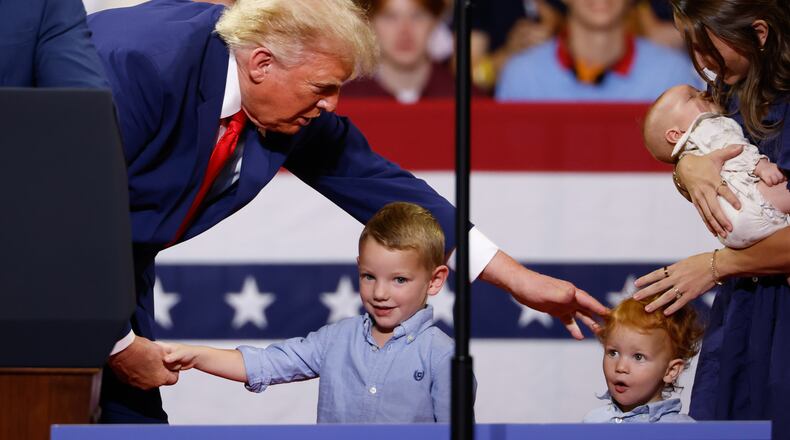 President Donald Trump greets members of the Loden family, who signed up for Trump Accounts, during his rally at Wheeler High School on Wednesday, July 22, 2026, in Marietta. (Arvin Temkar/AJC)