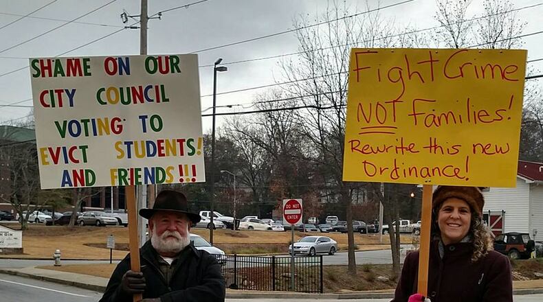 Curtis Hamilton, right, and Kathleen Allen protest outside the Crossland Atlanta hotel Tuesday morning.