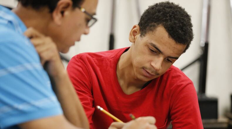Christian Robinson (right) gets math tutoring from teacher Aleem Shaw to help bring him up to a high school level. BOB ANDRES / BANDRES@AJC.COM