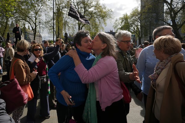 Women's rights activists celebrate outside the Supreme Court to challenge gender recognition laws, in London, Wednesday, April 16, 2025. (AP Photo/Kin Cheung)