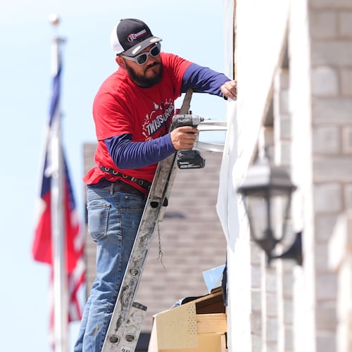 A worker installs a window on a house under construction in Richardson, Texas, Monday, March 23, 2026. (AP Photo/LM Otero)