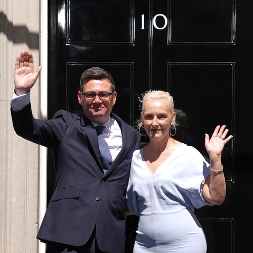 Britain's new Prime Minister Andy Burnham and his wife Marie-France van Heel wave as they arrive at 10 Downing Street in London, Monday, July 20, 2026.(AP Photo/Kirsty Wigglesworth)