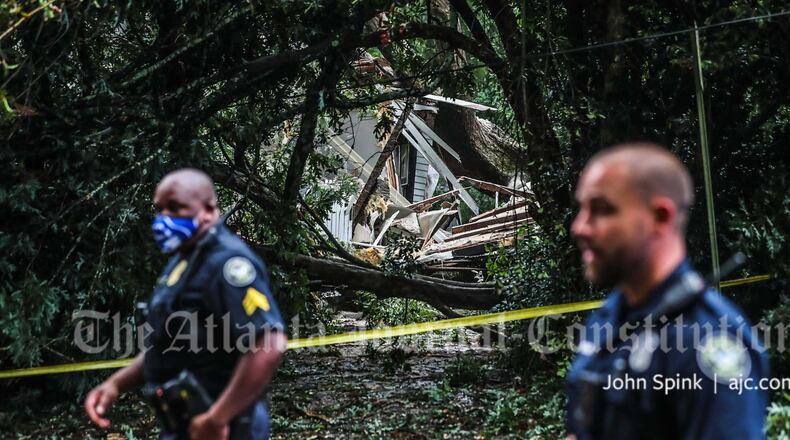 A woman was trapped after a tree fell on this house in the Candler Park neighborhood.