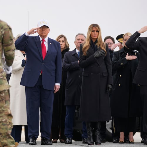 An Army carry team moves a flag-draped transfer case with the remains of U.S. Army Reserve soldier Sgt. 1st Class Nicole Amor, of White Bear Lake, Minn., who was killed in a drone strike at a command center in Kuwait after the U.S. and Israel launched its military campaign against Iran, past President Donald Trump and first lady Melania Trump during a casualty return, Saturday, March 7, 2026, at Dover Air Force Base, Del. (AP Photo/Mark Schiefelbein)