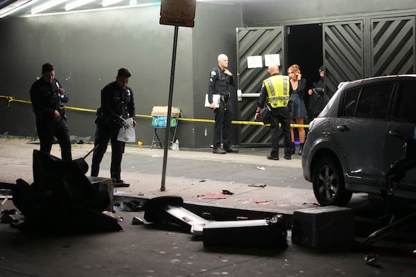 Law enforcement investigate the scene where a vehicle rammed into a crowd of people waiting to enter a nightclub along a busy boulevard in Los Angeles early Saturday, July 19, 2025 injuring several people. (AP Photo/Damian Dovarganes)