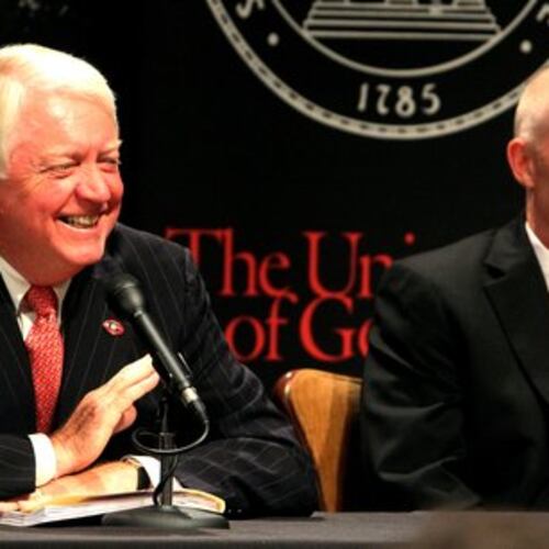 University of Georgia President Michael F. Adams (left) shares a laugh with then-interim athletic director Frank Crumley. (AJC file)