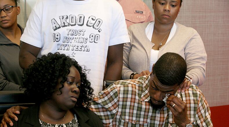 Odell Edwards wipes away tears as he sits with his wife, Charmaine Edwards, listening to their attorney Lee Merritt talking about the death of their son, Jordan Edwards, in a police shooting Saturday in Balch Springs, Texas, in Merritt's law office in Dallas, Monday, May 1, 2017. A suburban Dallas police chief said Monday that his department wrongly described why an officer fired into a moving vehicle and killed Jordan Edwards, after an attorney for the boy's family said officers were trying to "justify the unjustifiable."