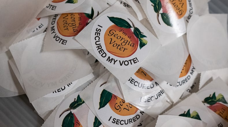 201012-Decatur-A box of stickers sits inside the early polling station Monday morning October 12, 2020 at the DeKalb County elections office in Decatur. Ben Gray for the Atlanta Journal-Constitution