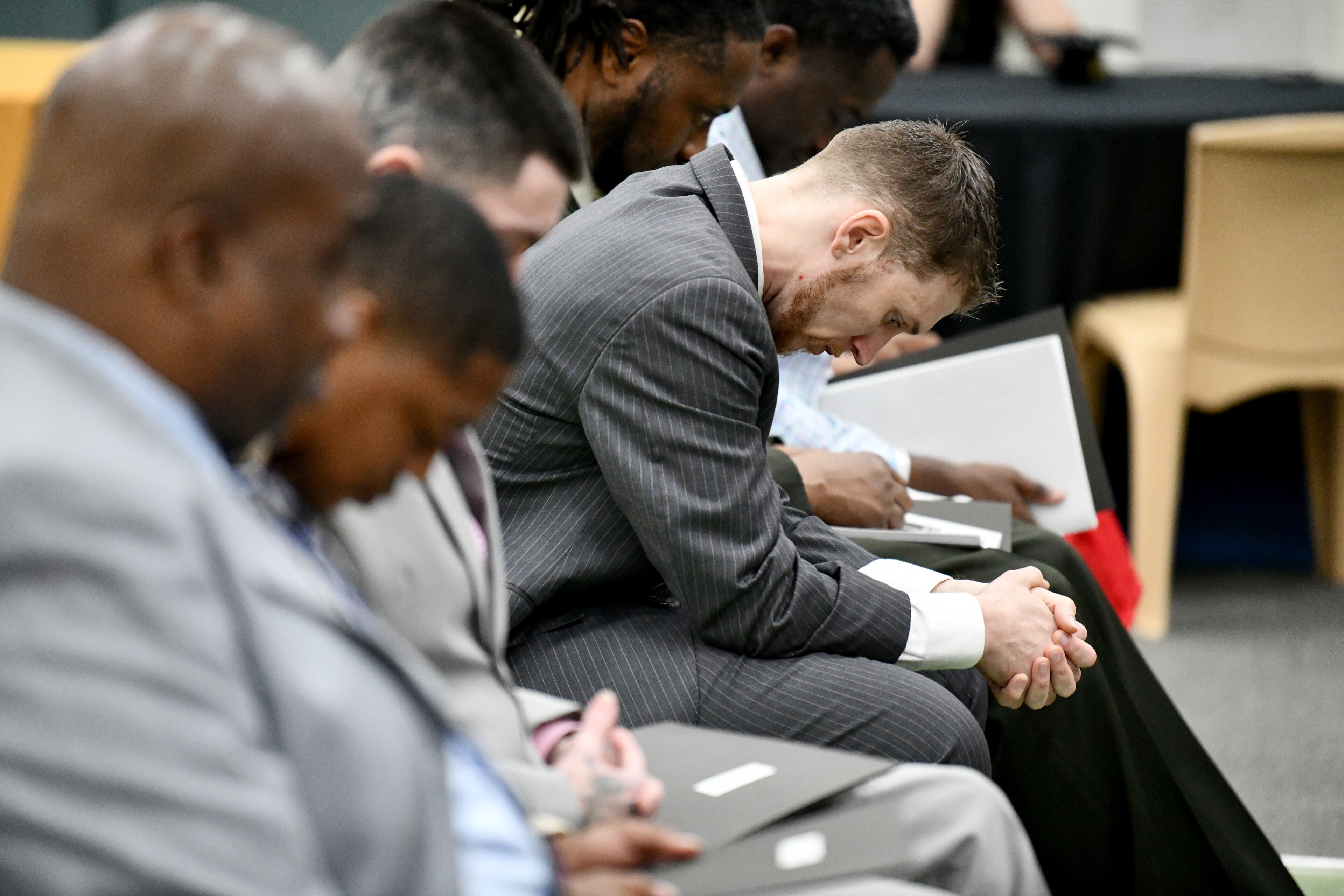 Program graduates, including Cameron Stockton (center), pray during a graduation ceremony for the Re-Entry Success Program at the Athens-Clarke County Jail on Wednesday, June 18, 2025, in Athens. (Hyosub Shin/AJC)