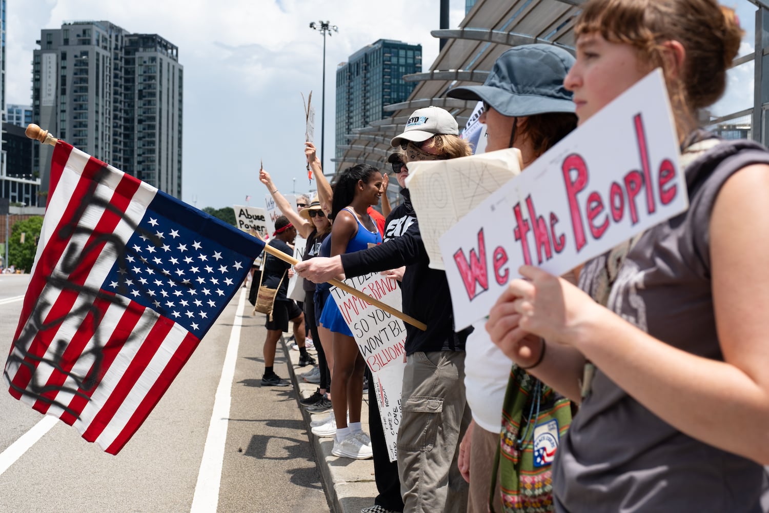 People gather on the 17th Street bridge  in Atlanta as part of the nation-wide No Kings protests Saturday, June 14, 2025.   Ben Gray for the Atlanta Journal-Constitution