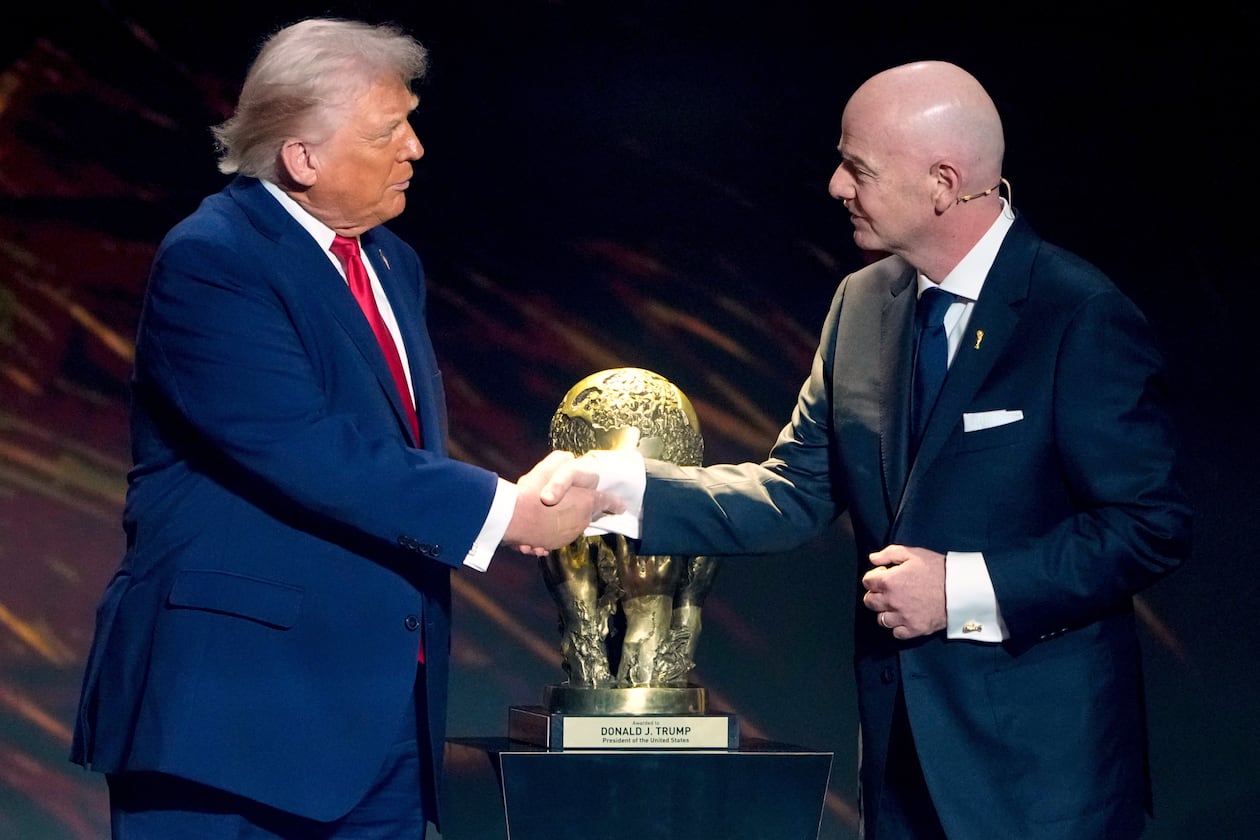 FILE - FIFA President Gianni Infantino, right, awards President Donald Trump with the FIFA Peace Prize during the draw for the 2026 soccer World Cup at the Kennedy Center in Washington, Dec. 5, 2025. (AP Photo/Chris Carlson, File)