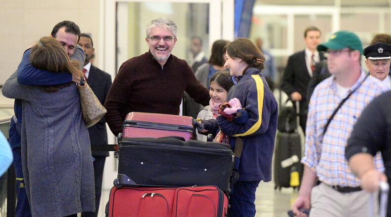 JANUARY 28, 2017 ATLANTA Mansour Kenereh (center in purple sweater) reunites with family members in the International arrivals lobby at Hartsfield Jackson International Airport on Saturday Kent D. Johnson/AJC