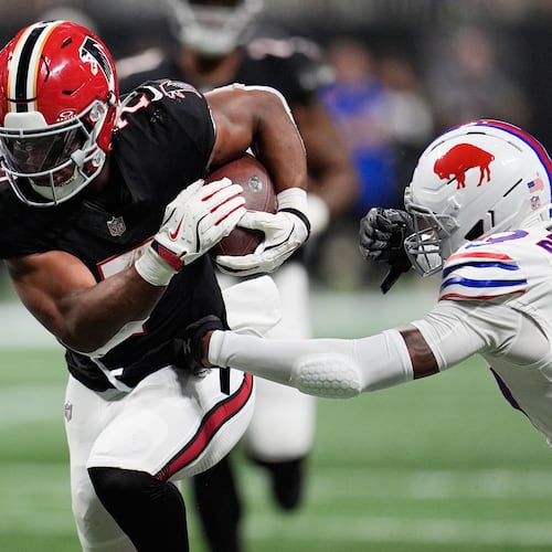 Atlanta Falcons running back Bijan Robinson (7) runs past Buffalo Bills cornerback Christian Benford (47) during the first half of an NFL football game, Monday, Oct. 13, 2025, in Atlanta. (AP Photo/Mike Stewart)