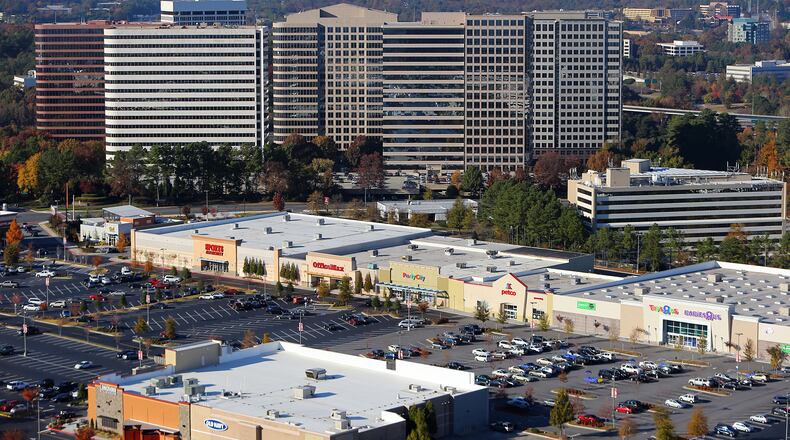 The Galleria Office Park rises above the businesses at Akers Mill Square seen looking north on Cobb Parkway on Thursday, Nov. 14, 2013. CURTIS COMPTON /staff CCOMPTON@AJC.COM