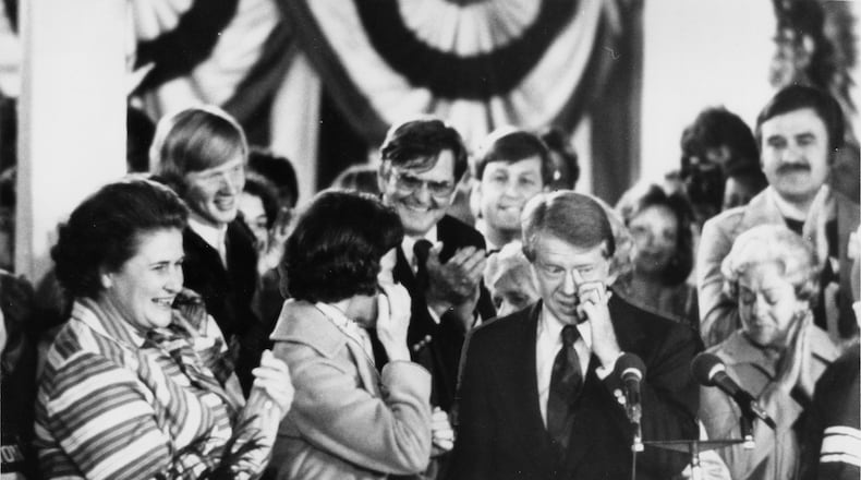 Jimmy and Rosalynn Carter wipe away tears at their greeting in Plains after winning the presidential election on Nov. 6, 1976. (Billy Downs / AJC file)