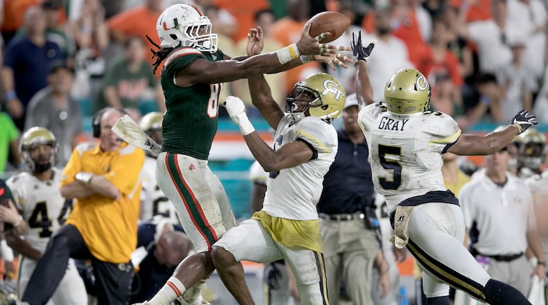 Miami Hurricanes wide receiver Darrell Langham (81) pulls in a pass on 4th down and 11 yards to go over Georgia Tech Yellow Jackets defensive back Lamont Simmons (6) and Georgia Tech Yellow Jackets defensive back A.J. Gray (5) to set up winning fieldgoal at Hard Rock Stadium in Miami Gardens, Florida on October 14, 2017. (Allen Eyestone / The Palm Beach Post)
