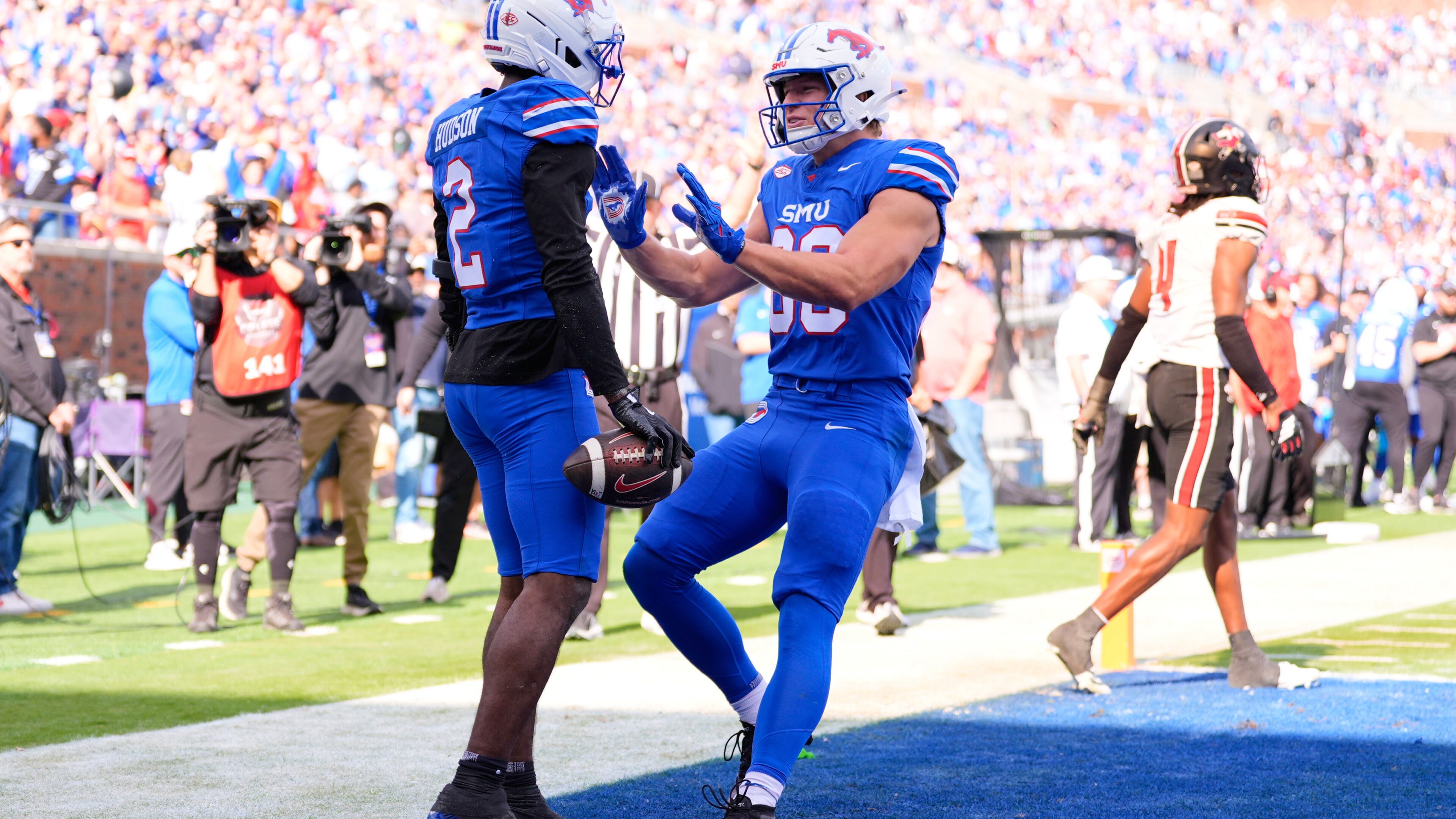 SMU wide receiver Jordan Hudson (2) and tight end Matthew Hibner (88) celebrate Hudson's touchdown catch in the first ihalf of an NCAA college football game against Louisville Saturday, Nov. 22, 2025, in Dallas. (AP Photo/Tony Gutierrez)