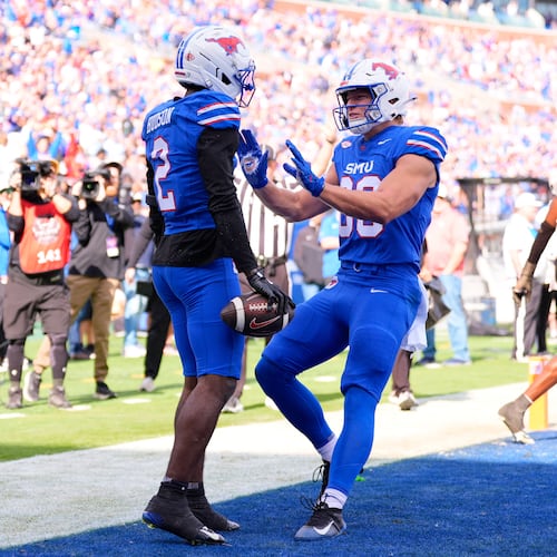 SMU wide receiver Jordan Hudson (2) and tight end Matthew Hibner (88) celebrate Hudson's touchdown catch in the first ihalf of an NCAA college football game against Louisville Saturday, Nov. 22, 2025, in Dallas. (AP Photo/Tony Gutierrez)