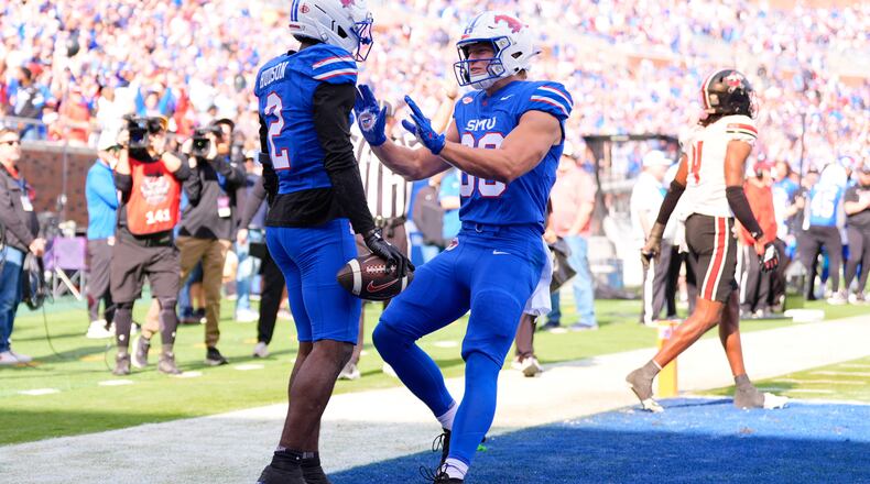 SMU wide receiver Jordan Hudson (2) and tight end Matthew Hibner (88) celebrate Hudson's touchdown catch in the first ihalf of an NCAA college football game against Louisville Saturday, Nov. 22, 2025, in Dallas. (AP Photo/Tony Gutierrez)