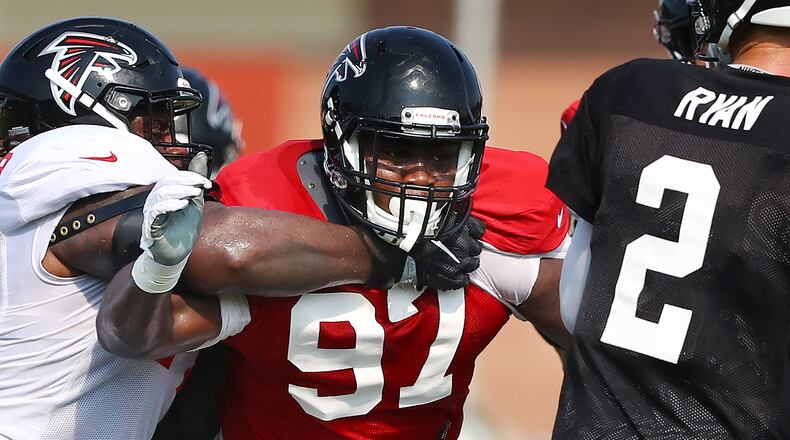 Atlanta Falcons defensive tackle Grady Jarrett (97) applies a little token heat to quarterback Matt Ryan in preseason camp. (Curtis Compton/ccompton@ajc.com)