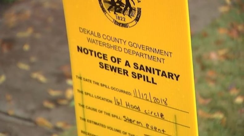 <p>Workers putting down lime after sewage spills in DeKalb County</p> <p>Signs indicating a sewer spill in DeKalb County</p>
