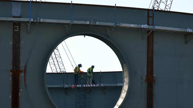 In this 2015 photo, workers inside the partly constructed containment structure on of one of the two new nuclear power plants being built at Plant Vogtle. AJC/file
