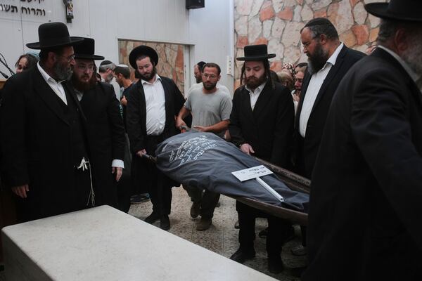 Mourners carry the body of Tzeela Gez, 37, an Israeli who was on her way to have her baby delivered when she was shot and killed by a Palestinian gunman in the occupied West Bank, during her funeral at Givat Shaul cemetery in Jerusalem on Thursday, May 15, 2025. (AP Photo/Ohad Zwigenberg)