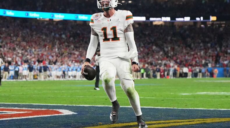 Miami quarterback Carson Beck scores a touchdown during the second half of the Fiesta Bowl NCAA college football playoff semifinal game against Mississippi, Thursday, Jan. 8, 2026, in Glendale, Ariz. (AP Photo/Rick Scuteri)