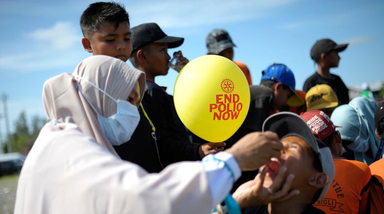 FILE - A medical worker gives a vaccine to a boy during a polio immunization campaign at Sigli Town Square in Pidie, Aceh province, Indonesia, Nov. 28, 2022. (AP Photo/Riska Munawarah, File)