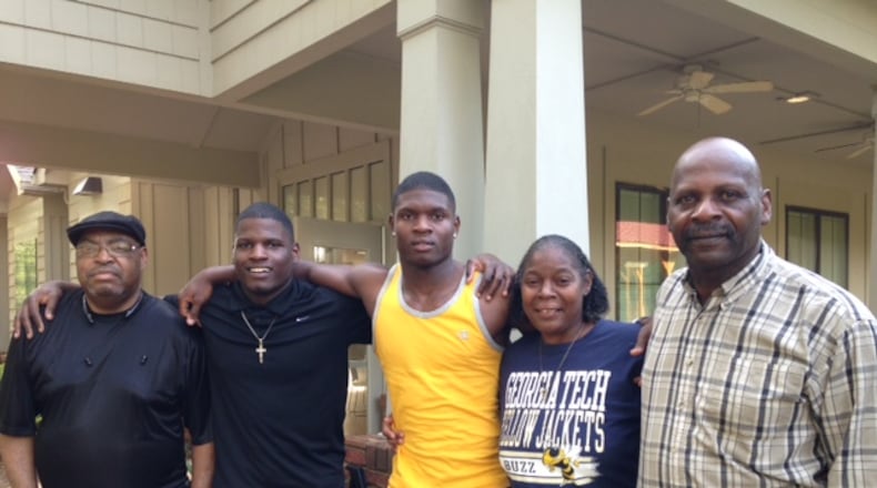 Georgia Tech signee Jaquan Henderson (yellow shirt) poses with his family in front of the Nelson Heights Community Center in Covington with, from left, his grandfather James Russell, his brother Anthony, his mother Sandy and his father J.C. (AJC photo by Ken Sugiura)