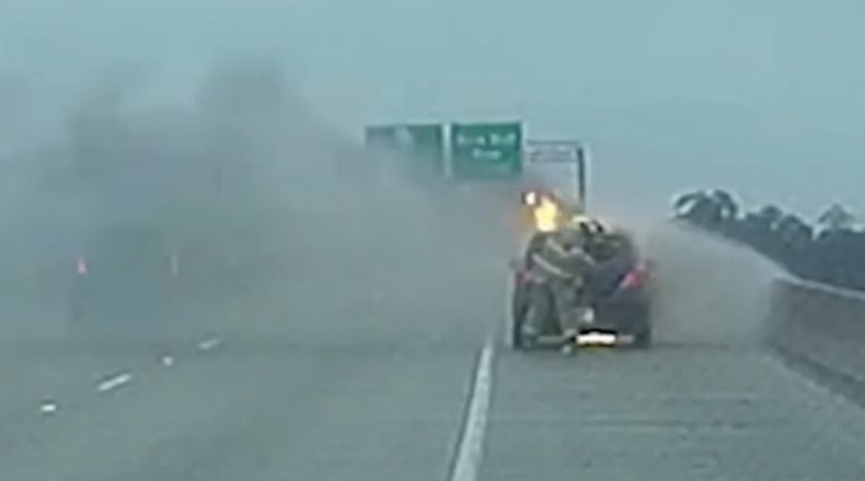 A firefighter saved a woman who was trapped inside her burning vehicle, according to a Facebook post by Chatham Emergency Services. (Chatham Emergency Services screen shot)