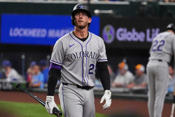 Colorado Rockies' Ryan McMahon walks to the dugout after striking out during the ninth inning of a baseball game against the Texas Rangers, Wednesday, May 14, 2025, in Arlington, Texas. (AP Photo/LM Otero)