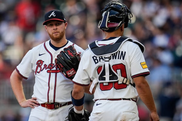 Atlanta Braves pitcher Davis Daniel (58) speaks with catcher Drake Baldwin (30) in the second inning of a baseball game against the San Francisco Giants, Tuesday, July 22, 2025, in Atlanta. (AP Photo/Mike Stewart)