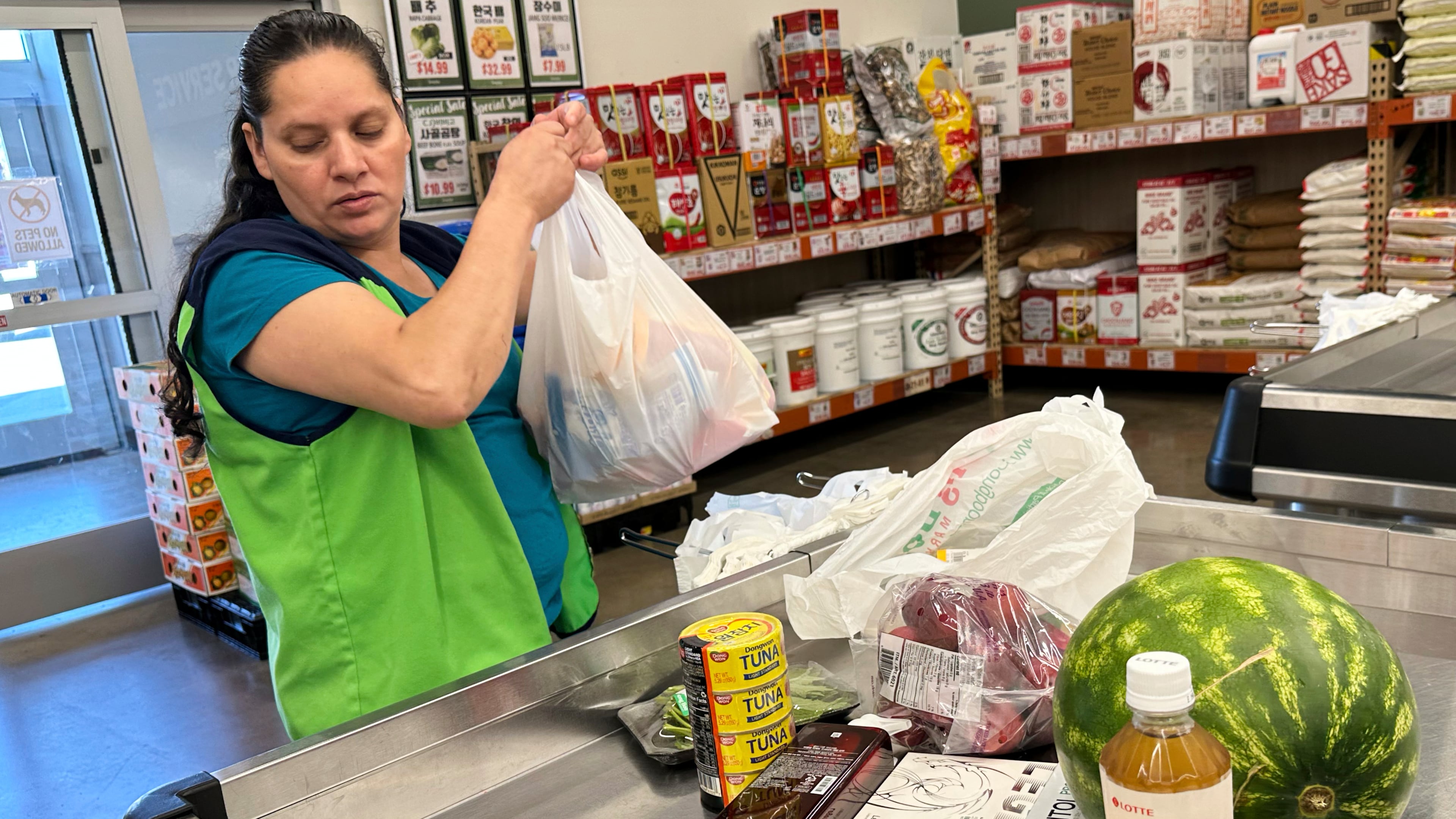 An employee works at a cash register in a grocery store in Schaumburg, Ill., Thursday, Sept. 18, 2025. (AP Photo/Nam Y. Huh)