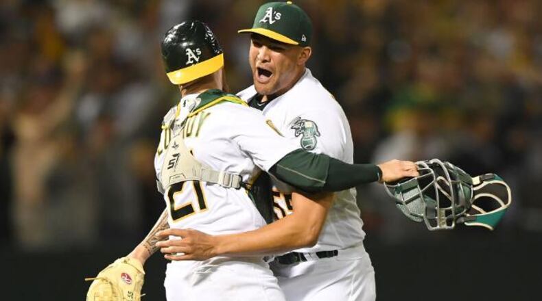 OAKLAND, CA - APRIL 21:  Sean Manaea #55 and Jonathan Lucroy #21 of the Oakland Athletics celebrate after Manaea pitched a no-hitter against the Boston Red Sox at the Oakland Alameda Coliseum on April 21, 2018 in Oakland, California. The Athletics won the game 3-0.  (Photo by Thearon W. Henderson/Getty Images)