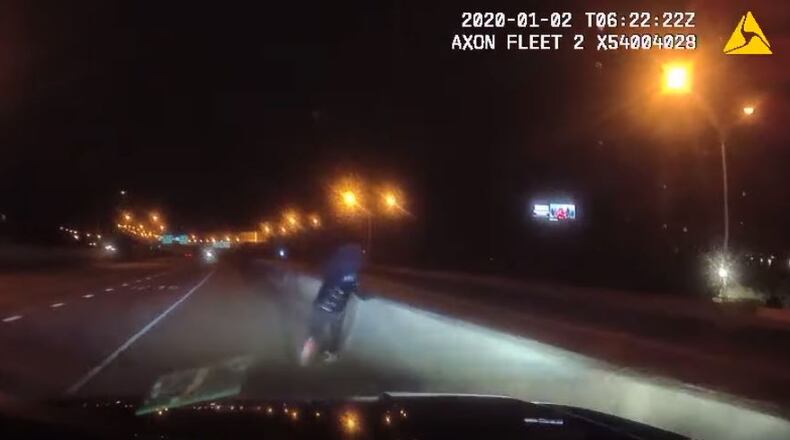 This is a screenshot of dash camera video released Thursday afternoon of the suspect about to jump off I-85.