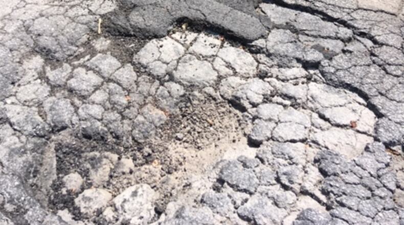Anne Palmer hopes this pothole will soon be a thing of the past. (Photo/Anne Palmer)