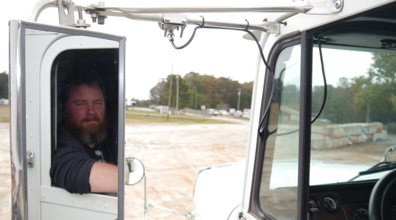 As last year year ended, the hottest hiring in metro Atlanta was in transportation and warehousing, part of the struggle to ramp up deliveries ,storage and handling of goods. Here, Chad Roberts, who owns a small trucking company, delivers a forklift in metro Atlanta. (Christopher Quinn/AJC)