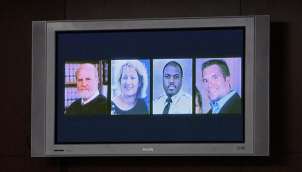 The four victims are shown on a courtroom monitor in mid-December 2008. Nichols had earlier admitted killing Superior Court Judge Rowland Barnes, who was overseeing his rape trial, Barnes' court reporter, Julie Ann Brandau, and Sheriff's Deputy Sgt. Hoyt Teasley, who pursued Nichols, on March 11, 2005. David Wilhelm, an off-duty federal agent, was gunned down during a robbery that night.
